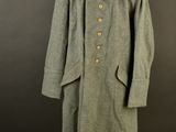 an image of a coat on a mannequin stand against a black background