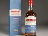 the bottle of benromach is next to a box of whisky