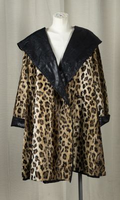 a woman ' s leopard print coat on a mannequin mannequin stand