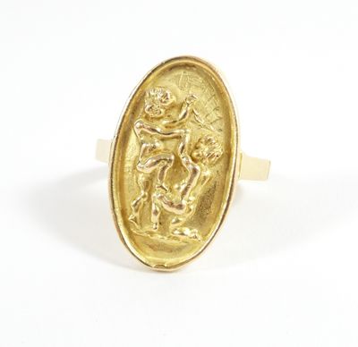 a close up of a gold ring with an image of a man on a horse