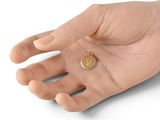 someone is holding a coin in their hand on a white surface