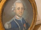 portrait of a man in a blue uniform in a gold frame