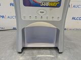 a close up of a soda dispenser sitting on a counter