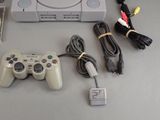 a video game console and a game controller on a table