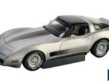 a silver model of a corvette car on a white background