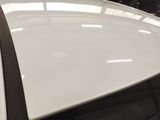 a close up of a white car with a black stripe