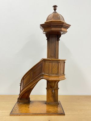 an image of a wooden stair case with a wooden handrail