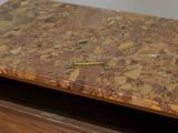 a close up of a wooden desk with a marble top