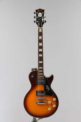 an electric guitar on a stand against a white background