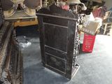 a black cabinet in the middle of a room full of furniture
