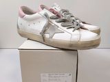 a box with a pair of white sneakers on it