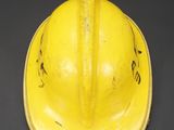 a yellow hard hat on a black background