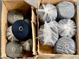 many balls of yarn in a box on the floor