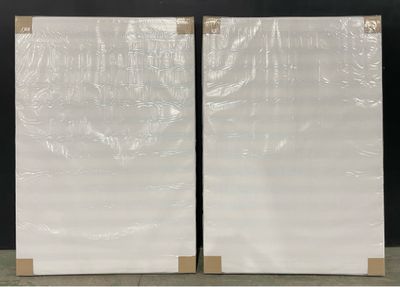 two pieces of white marble sitting on a table