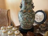 a table with a lamp, plates, cups, and cookies on it