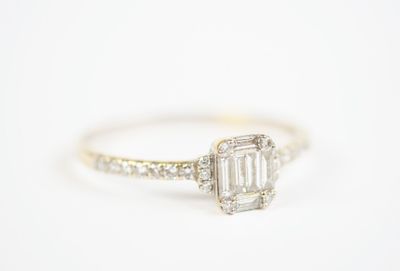 a white gold engagement ring with a baguet cut diamond