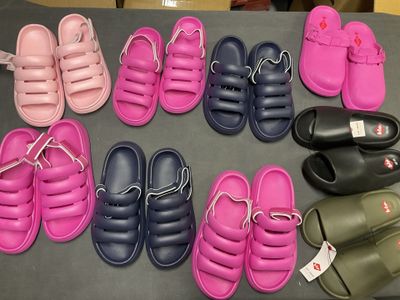 many pairs of sandals that are on a table