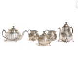 four pieces of silver tea and coffee set on a white background