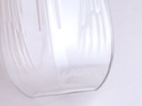 a close up of a glass vase on a white surface