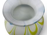 a white bowl with a yellow and blue design on it