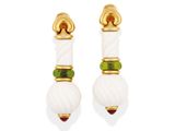 a pair of earrings with white and green beads
