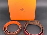 a hermes belt with a gold buckle and two matching belts