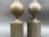 pair of brass table lamps with marble bases and lampshads