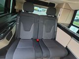 two seats in the back of a van that is empty