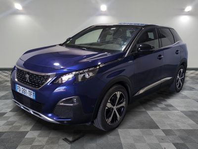 une voiture bleue est garée dans une pièce au sol à carreaux