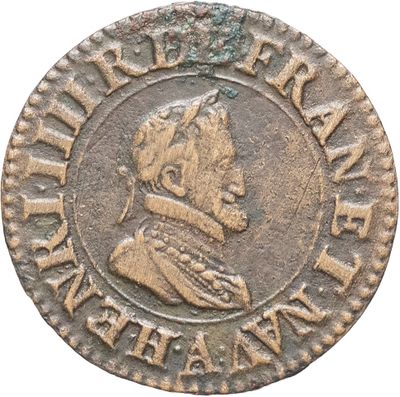 Gros plan sur une pièce de monnaie représentant un homme.