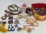 a lot of jewelry sitting on a white surface