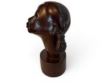 sculpture of a woman ' s head on a wooden base on a white background