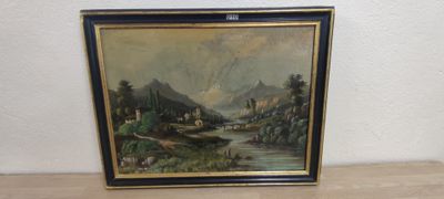 une vieille photo représentant un tableau représentant un paysage de montagne posé sur une table