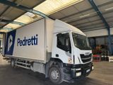 a white truck that is parked in a warehouse