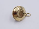 an image of a gold plated metal object on a white surface