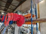 a room with a bunch of red and blue hoses on the shelves
