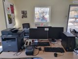 a computer desk with two monitors and a printer on it