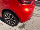 a red car that is parked on the side of the street