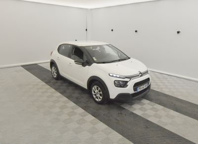 the small white car is parked in the garage of the house
