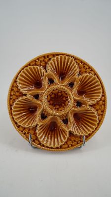 a close up of a plate with a flower design on it