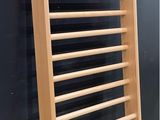 a wooden rack that is leaning against a wall
