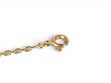 a close up of a gold chain with a ball on it