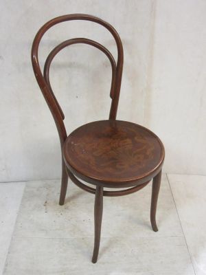 a wooden chair with a bent back and a wooden seat