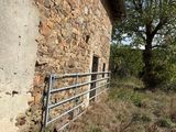 a stone building with a metal fence in front of it