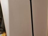 a black floor lamp that is on a wooden floor
