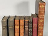 plusieurs vieux livres sont alignés sur une surface blanche