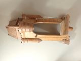 a small wooden model of a castle on a table