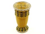 a yellow vase with a black and white design on it