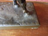 a bronze statue of a horse on a wooden table
