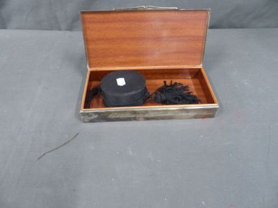 a small box with a hat and a hair brush in it